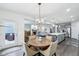 Bright dining area opens to a living room and kitchen with a wooden table and chairs at 14458 Carlow Run, Carmel, IN 46074