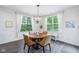 Bright dining area featuring wood floors and bright windows at 14458 Carlow Run, Carmel, IN 46074