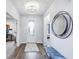 Inviting foyer with hardwood floors, a stylish mirror, and a view into adjacent rooms at 14458 Carlow Run, Carmel, IN 46074