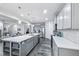 Bright kitchen features a large island with sink, stainless steel appliances, and gray cabinets at 14458 Carlow Run, Carmel, IN 46074