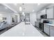 Spacious kitchen with a large island featuring white countertops and sink with seating and gray cabinets at 14458 Carlow Run, Carmel, IN 46074