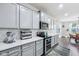 Modern kitchen features white cabinetry, stainless steel appliances and white countertops at 14458 Carlow Run, Carmel, IN 46074