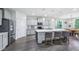 Spacious kitchen featuring a large island with seating, light gray cabinets and stainless steel appliances at 14458 Carlow Run, Carmel, IN 46074