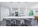 Kitchen island featuring quartz countertop, sink, and space for seating at 14458 Carlow Run, Carmel, IN 46074
