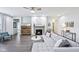 Open living room featuring hardwood floors, a cozy fireplace, and a comfortable sectional sofa at 14458 Carlow Run, Carmel, IN 46074