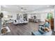 Open-concept living room features gray wood floors and connects to the kitchen with a large central island at 14458 Carlow Run, Carmel, IN 46074