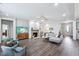 Spacious living room featuring hardwood floors, a fireplace, and cozy seating arrangements at 14458 Carlow Run, Carmel, IN 46074