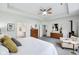 Sunlit main bedroom with a ceiling fan, hard surface floors, a chair and modern decor at 14458 Carlow Run, Carmel, IN 46074