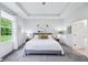Bedroom features tray ceilings, large windows, and modern decor with a ceiling fan at 14458 Carlow Run, Carmel, IN 46074