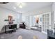 Functional home office featuring neutral carpeting, a modern desk setup, and French doors to a lounge area at 14458 Carlow Run, Carmel, IN 46074