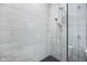 Bright shower featuring a rainfall showerhead and handheld sprayer against tiled walls at 14458 Carlow Run, Carmel, IN 46074