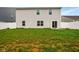 Large backyard with grass, privacy fence, and sliding glass door to patio at 1454 Silver Pine Ln, Sheridan, IN 46069