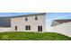 Back of home with access sliding glass door, small yard, and white fencing at 1454 Silver Pine Ln, Sheridan, IN 46069