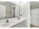Bathroom with dual sinks, modern fixtures, ornate mirror and bright white cabinets at 1454 Silver Pine Ln, Sheridan, IN 46069