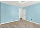 Bright bedroom featuring light blue paint, plush carpet, bright trim and contemporary lighting at 1454 Silver Pine Ln, Sheridan, IN 46069