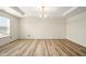 Spacious bedroom with hardwood floors, modern lighting, and a view of the outside at 1454 Silver Pine Ln, Sheridan, IN 46069