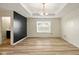 Bright bedroom with hardwood floors, a modern light fixture, and a large window at 1454 Silver Pine Ln, Sheridan, IN 46069