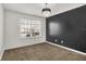 Bright bedroom features neutral carpet, a modern light fixture, and a sleek accent wall at 1454 Silver Pine Ln, Sheridan, IN 46069