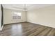 Bedroom features laminate flooring, tray ceiling, modern lighting and a large window at 1454 Silver Pine Ln, Sheridan, IN 46069