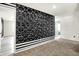 Bedroom features carpet, designer accent wall, and open doorways to additional rooms at 1454 Silver Pine Ln, Sheridan, IN 46069
