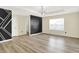 Spacious bedroom features laminate flooring, designer accent wall, and a modern light fixture at 1454 Silver Pine Ln, Sheridan, IN 46069