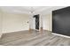 Bedroom with laminate flooring, designer accent wall, tray ceiling, and modern lighting at 1454 Silver Pine Ln, Sheridan, IN 46069