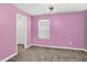 Charming pink bedroom with a modern light fixture, plush carpet, and a view to the closet at 1454 Silver Pine Ln, Sheridan, IN 46069