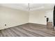 Bedroom featuring laminate flooring, tray ceiling, modern lighting, and an open doorway at 1454 Silver Pine Ln, Sheridan, IN 46069
