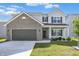 Charming two-story home with a well-manicured lawn, attached garage and a mix of brick and siding exterior at 1454 Silver Pine Ln, Sheridan, IN 46069