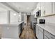 Open kitchen with an island, stainless steel appliances, and white and gray cabinets. Perfect for cooking! at 1454 Silver Pine Ln, Sheridan, IN 46069