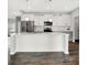 Modern kitchen featuring stainless steel appliances, center island, white cabinetry, and stylish pendant lighting at 1454 Silver Pine Ln, Sheridan, IN 46069