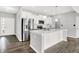 Modern kitchen featuring stainless steel appliances, center island, white cabinetry, and stylish pendant lighting at 1454 Silver Pine Ln, Sheridan, IN 46069