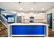 Stylish kitchen with white cabinets, stainless steel appliances, and a blue center island at 1454 Silver Pine Ln, Sheridan, IN 46069