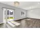 Bright living room featuring hardwood floors, a decorative light fixture, and sliding glass doors to the backyard at 1454 Silver Pine Ln, Sheridan, IN 46069