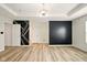 Bright room featuring tray ceilings, light laminate floors, and large windows at 1454 Silver Pine Ln, Sheridan, IN 46069