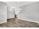Spacious living area with gray walls and dark wood floors, leading to the kitchen with updated appliances at 1454 Silver Pine Ln, Sheridan, IN 46069