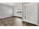 Open-concept living area featuring modern gray walls, a sparkling chandelier, and vinyl plank flooring at 1454 Silver Pine Ln, Sheridan, IN 46069