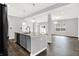 Spacious open floorplan with a kitchen island, stainless steel appliances, and contemporary lighting at 1454 Silver Pine Ln, Sheridan, IN 46069
