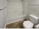Clean bathroom featuring a combined bathtub and shower with white tile surround at 15110 Fawn Hollow Ln, Noblesville, IN 46060