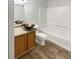 Bathroom featuring stylish vanity sink, wood-look flooring and bathtub-shower combo at 15110 Fawn Hollow Ln, Noblesville, IN 46060