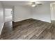 Spacious bedroom featuring wood-look flooring, ample natural light, and a ceiling fan at 15110 Fawn Hollow Ln, Noblesville, IN 46060