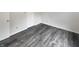 Bedroom with gray vinyl flooring and white trim, creating a sleek and modern look at 15110 Fawn Hollow Ln, Noblesville, IN 46060