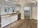 Stainless steel dishwasher in a kitchen with white cabinets and wood-look flooring at 15110 Fawn Hollow Ln, Noblesville, IN 46060