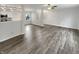 Bright living room with wood-look flooring, ceiling fan, and open floor plan at 15110 Fawn Hollow Ln, Noblesville, IN 46060