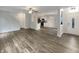 Open-concept living space showcasing wood floors and seamless flow into the kitchen at 15110 Fawn Hollow Ln, Noblesville, IN 46060