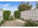 Cozy backyard patio with white fencing, mature plants and flowers at 15421 Bowie Dr, Westfield, IN 46074