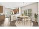 Bright dining area with hardwood floors, a modern light fixture, and open access to the kitchen at 15421 Bowie Dr, Westfield, IN 46074