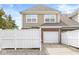 Exterior view of townhome with a garage, white fence, and neutral color siding at 15421 Bowie Dr, Westfield, IN 46074
