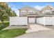 Exterior of townhome with a one-car garage, white fence, and landscaping at 15421 Bowie Dr, Westfield, IN 46074