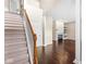 Inviting foyer with staircase, dark wood floors, and a view of the living room with a fireplace at 15421 Bowie Dr, Westfield, IN 46074